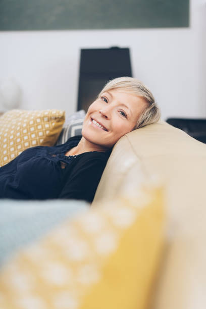 istock Happy friendly blond woman relaxing at home 1073559970