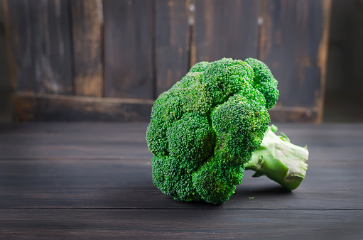 Healthy Green Organic Raw Fresh broccoli Florets on wooden table close up rustic style, old wooden background Ready for Cooking