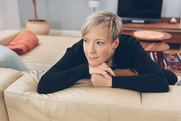 istock Woman sitting daydreaming at home 1073560770