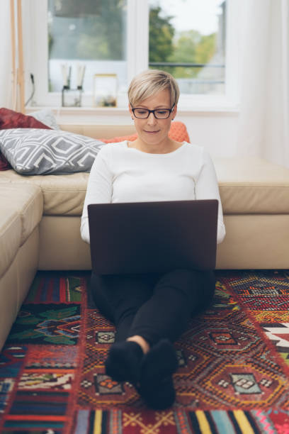 istock Blond woman relaxing on a colorful rug 1073560804