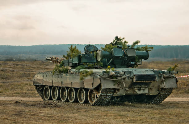 istock A tank hidden behind pine trees in polygon 1073577580