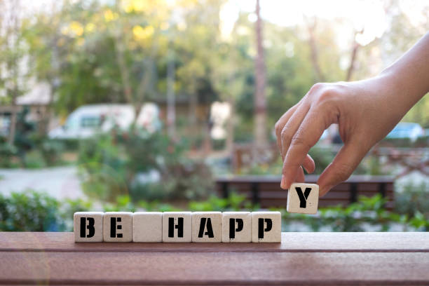 istock BE HAPPY Concept with Hand and alphabet blocks 1073581628