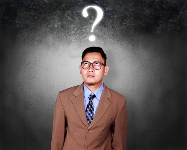 istock Confused Businessman with Question Mark 1073582394