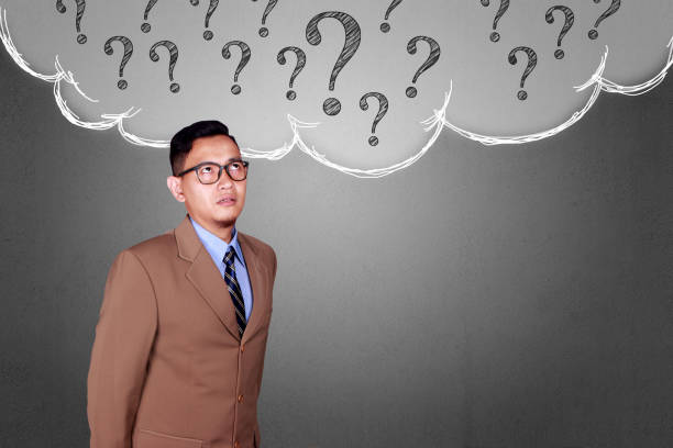 istock Confused Businessman with Question Mark 1073583482