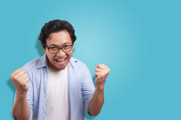 istock Young Man Happy, Celebrating Victory Gesture 1073584654