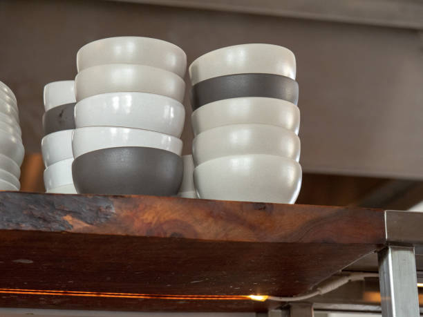 istock Stack of black and white ceramic bowls sitting on a restaurant shelf 1073587856