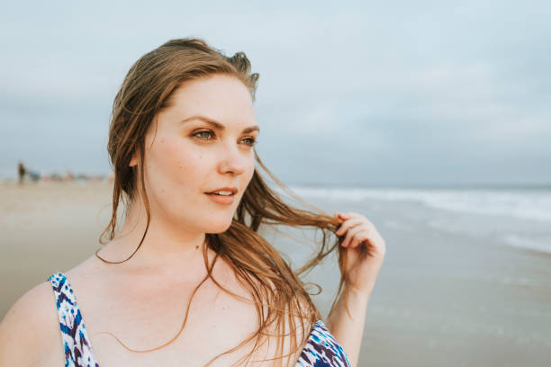 Confident blond plus size woman at the beach