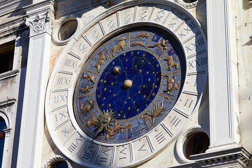 Gold zodiac signs and astronomical clock in a sunny day in Italy