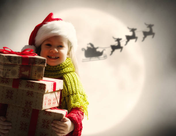 istock girl with present at Christmas 1073593716