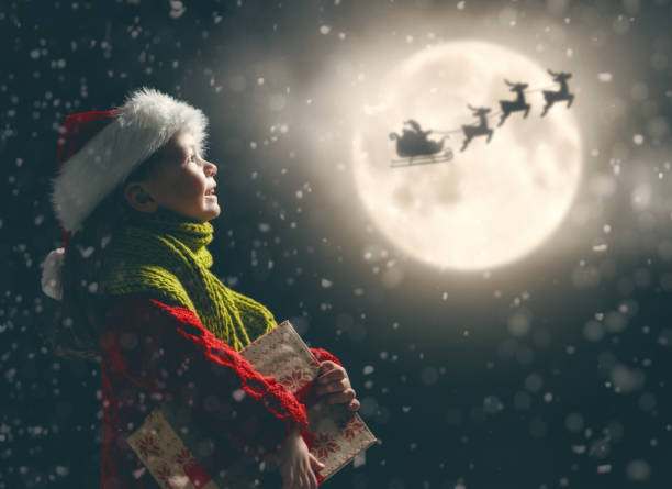istock girl with present at Christmas 1073593736