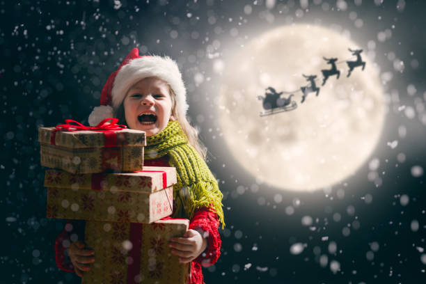 istock girl with present at Christmas 1073593740