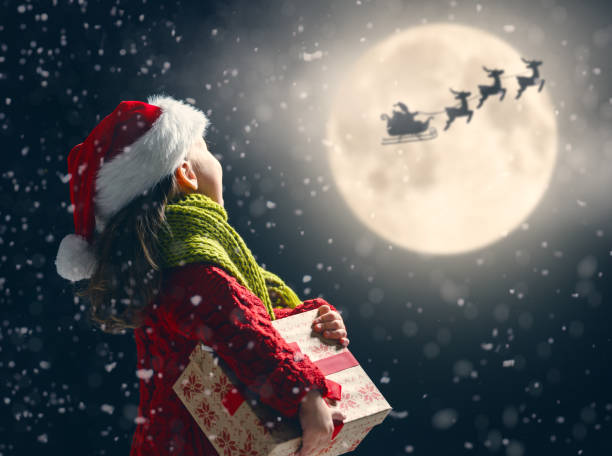 istock girl with present at Christmas 1073593760