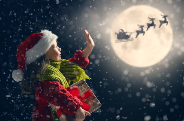 istock girl with present at Christmas 1073593768