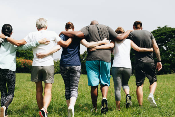 istock Group of people hugging in the park 1073593896