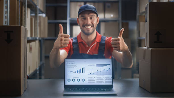 istock Happy Worker Shows Thumbs Up and Laptop Screen with Infographics Displaying Graph and Statistics with Annual Results Growth. 1073594204