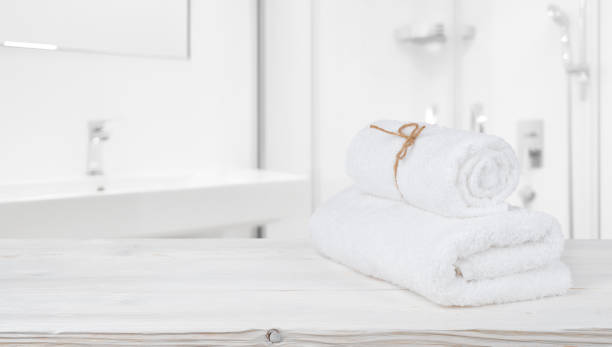 istock Spa towels on shelf in defocused bathroom with copy space 1073594846