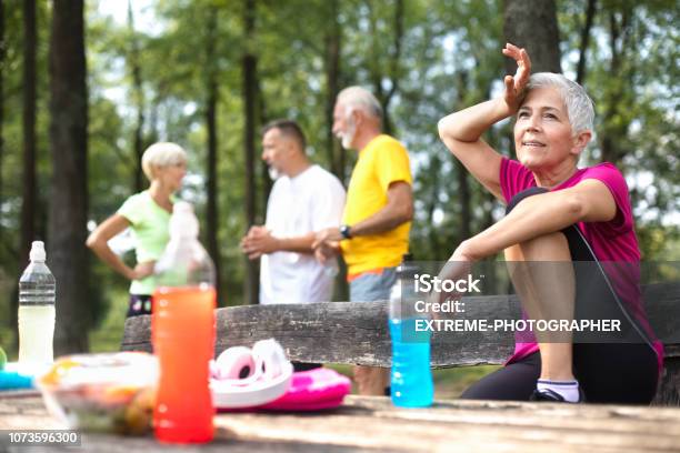 Active Senior People Taking A Break After An Exhausting Exercise Outdoors Stock Photo - Download Image Now