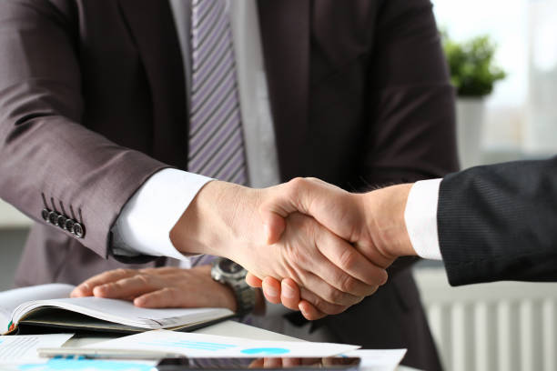 istock Man in suit shake hand as hello in office 1073596868