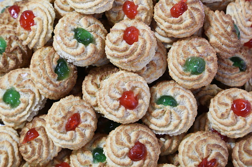 almond pastries decorated with candied fruit in a pastry shop