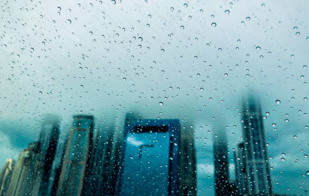istock Tall Skyscrapers of Dubai seen through wind shield during a rainy day 1073600510