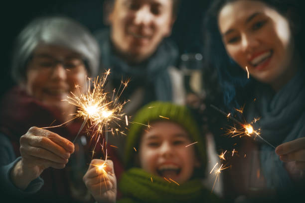 Family having fun on New Year. Merry Christmas and Happy Holiday! Family having fun on New Year. lighting fire cracker stock pictures, royalty-free photos & images