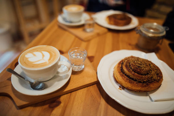 istock Coffee latte art on wood table with cookie 1073605372