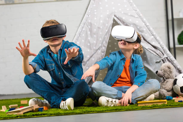 istock kids using virtual reality headsets and gesturing by hands near wigwam at home 1073605510