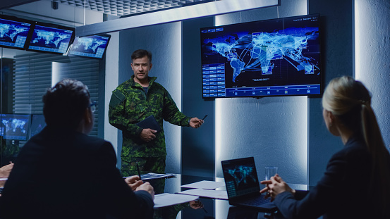 High-Ranking Military Man holds a Briefing to a Team of Government Agents and Politicians, Shows Satellite Surveillance Footage.