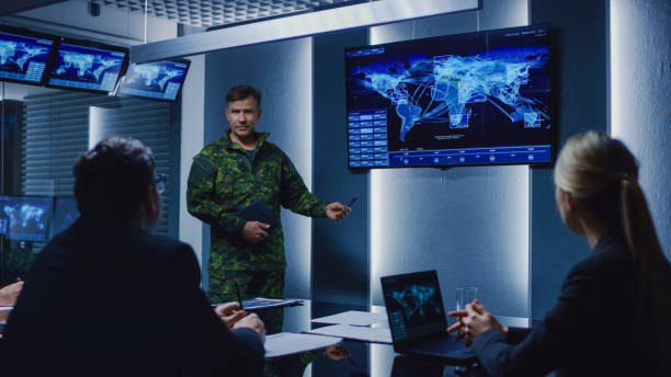 High-Ranking Military Man holds a Briefing to a Team of Government Agents and Politicians, Shows Satellite Surveillance Footage. High-Ranking Military Man holds a Briefing to a Team of Government Agents and Politicians, Shows Satellite Surveillance Footage. real estate office photos stock pictures, royalty-free photos & images