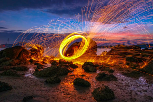 istock Spark fire swirl from steel wool over the rocks 1073609624