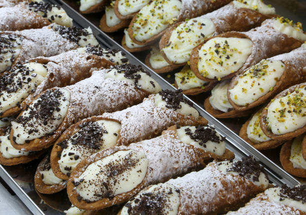 typical Sicilian cannoli stuffed with ricotta typical Sicilian cannoli stuffed with ricotta and chocolate and pistachio flakes cannoli photos stock pictures, royalty-free photos & images