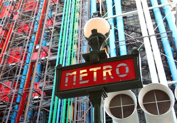 big road sign with text METRO that means subway in french language in Paris France Paris, France - August 19, 2018: road sign with text METRO that means subway in french language in Paris France and Pompidou Center in Background pompidou center stock pictures, royalty-free photos & images