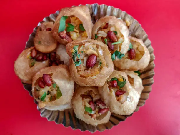 Dry pani puri served in a paper plate