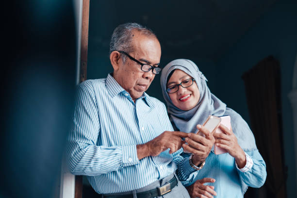 istock Senior Asian Couple Looking at Smartphone 1073615936