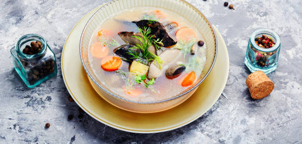 istock Mushroom soup on wooden background 1073626010