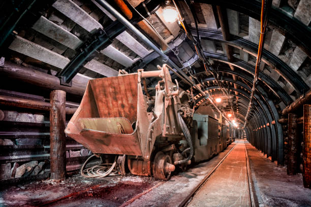 istock Coal mine underground corridor with freight railroad cars 1073629908