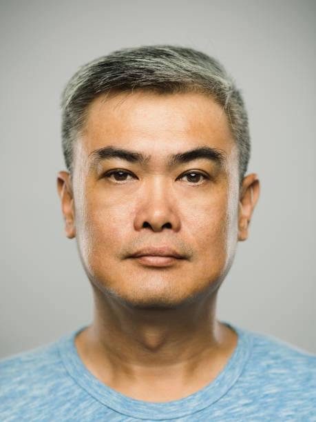 Real chinese mature man with blank expression stock photo