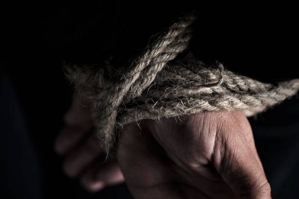 istock man with his hands tied behind his back 1073643878