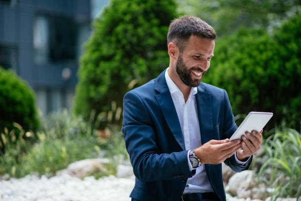 istock Handsome businessman working on a digital tablet 1073652366