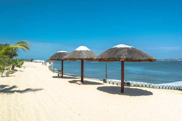 Three straw parasol, on tropical and paradisiac beach, in Angola Three straw parasol, on tropical and paradisiac beach, in Angola... luanda stock pictures, royalty-free photos & images