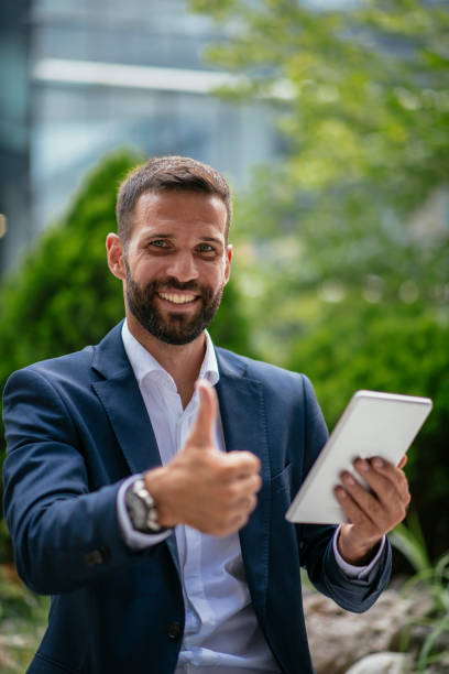 istock Handsome businessman working on a digital tablet 1073653592