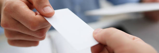 istock Male hand in suit give blank calling card tom man 1073656162