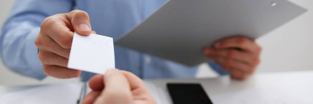 istock Male hand in suit give blank calling card tom man 1073656184