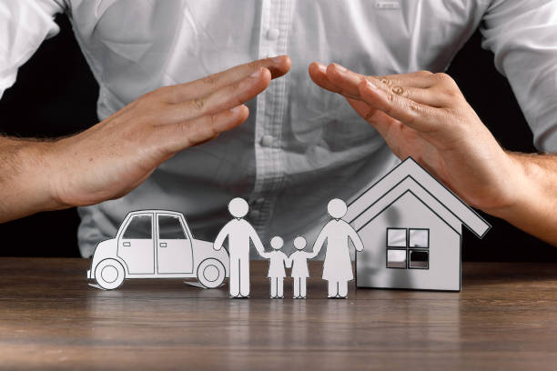 istock insurance house protection concepts, Hands post protect over house. 1073657118