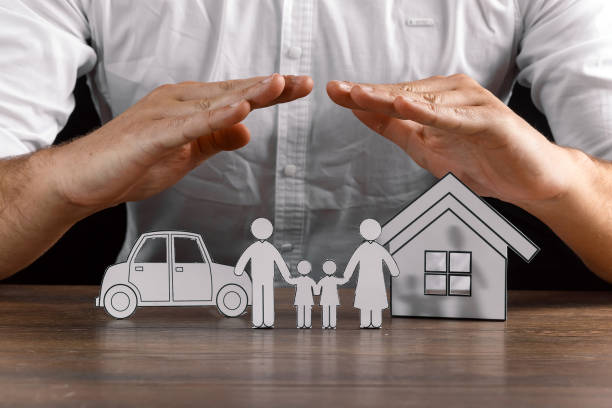istock insurance house protection concepts, Hands post protect over house. 1073657138