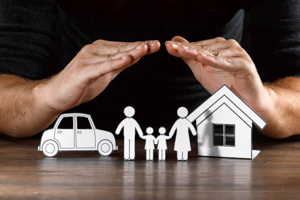 istock insurance house protection concepts, Hands post protect over house. 1073657168