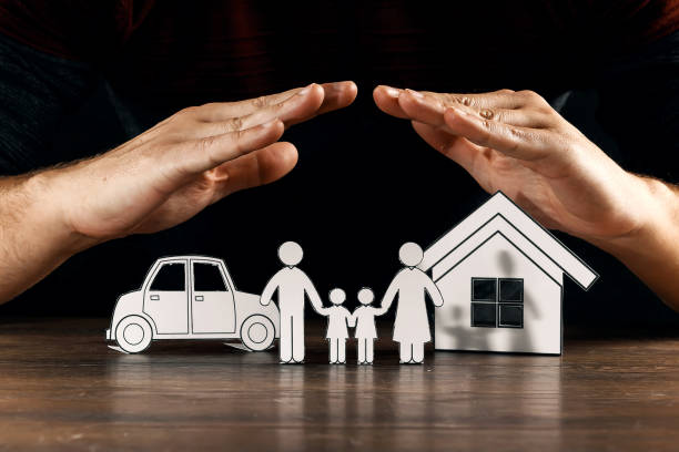 istock insurance house protection concepts, Hands post protect over house. 1073657194