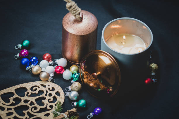 istock Christmas themed articles around a candle flame - background, copy space. 1073662314