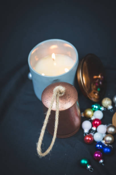 istock Christmas themed articles around a candle flame - background, copy space. 1073662436