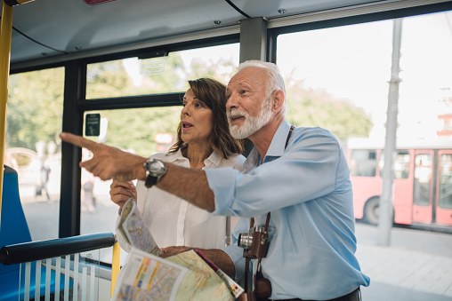 Senior couple riding on a bus and sightseeing